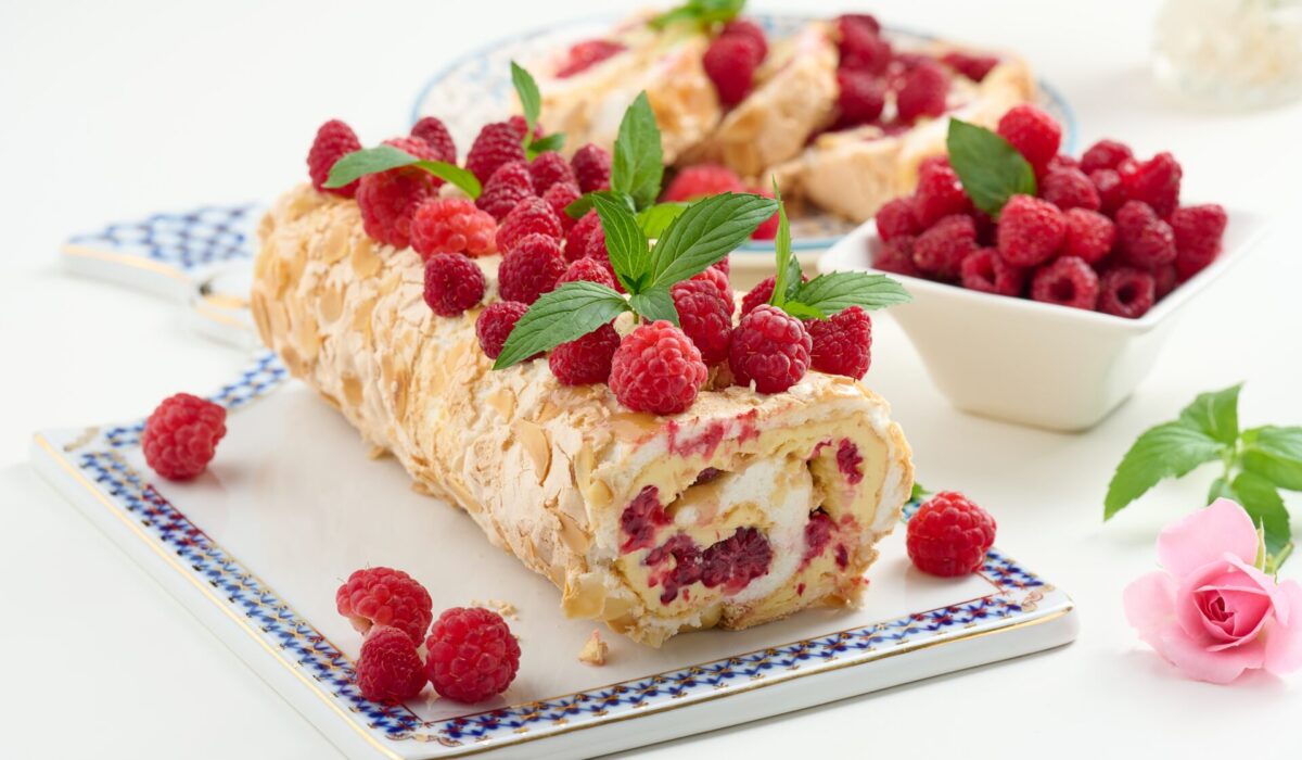 Baked,Meringue,Roll,With,Cream,And,Fresh,Red,Raspberry,On