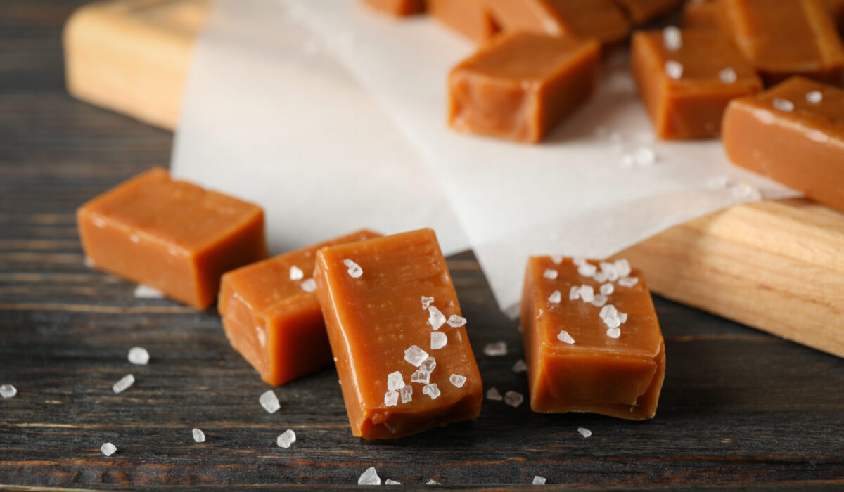 Salted,Caramel,Candies,On,Wooden,Background,,Close,Up,And,Copy