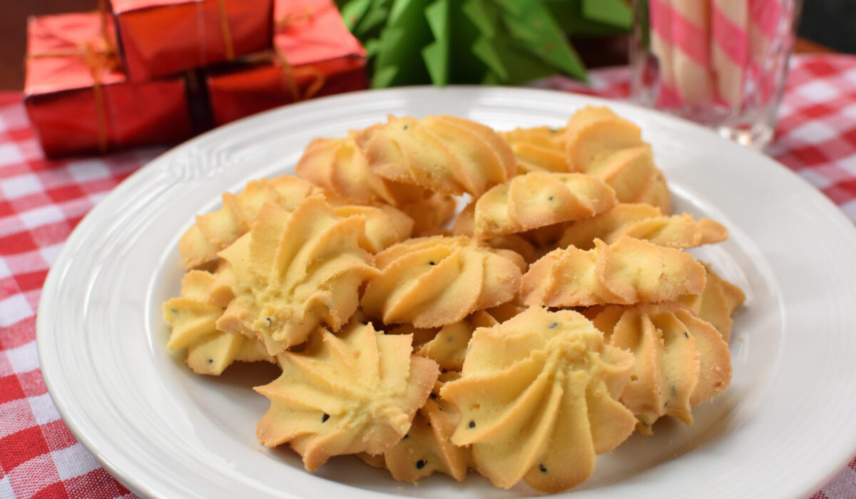 Black,Sesame,Butter,Cookies,On,White,Background.and,Christmas,Tree,Paper,