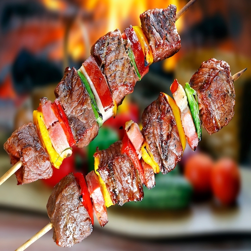 Meat skewer with bacon and vegetables