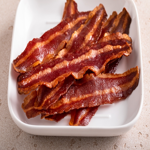 Turkey bacon crispy cooked on a white plate ready to eat