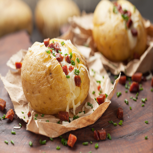 Baked potato with cheese and bacon. Close up