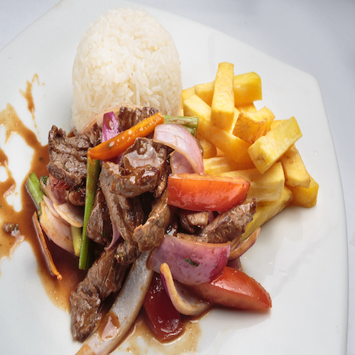 Peruvian food "lomo saltado":A salted beef with tomatoes, onion, fried potatoes and rice.