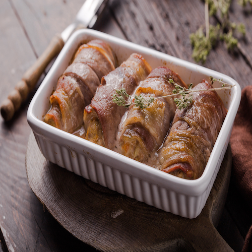 Grilled meat rolls wrapped in strips of bacon. Pork roll filled