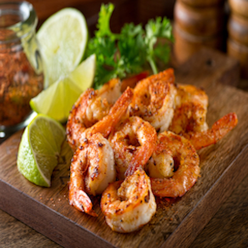 Delicious sauteed shrimp with cajun seasoning and lime on a maple plank.