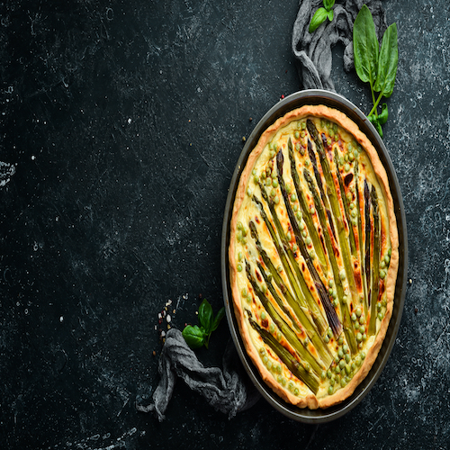 Puff pastry tart with asparagus and spices. Healthy food. Top view. Free space for your text.